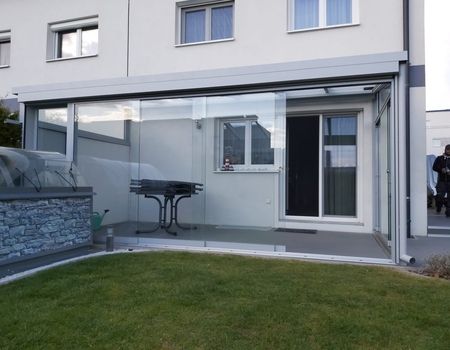 Ein Sommergarten mit Glasschiebetüren.